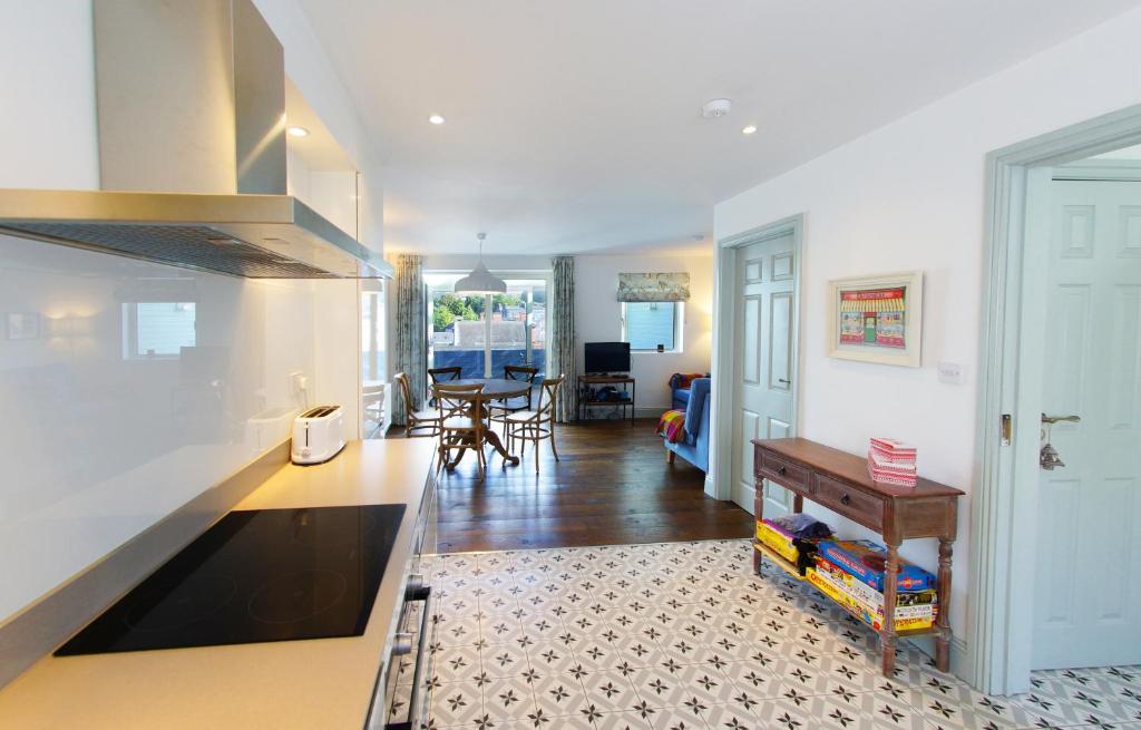 a kitchen with a counter top and a living room at Kinsale in Kinsale