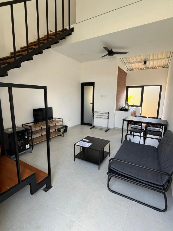 a living room with a couch and a table at Naung CoLiving in Kerobokan