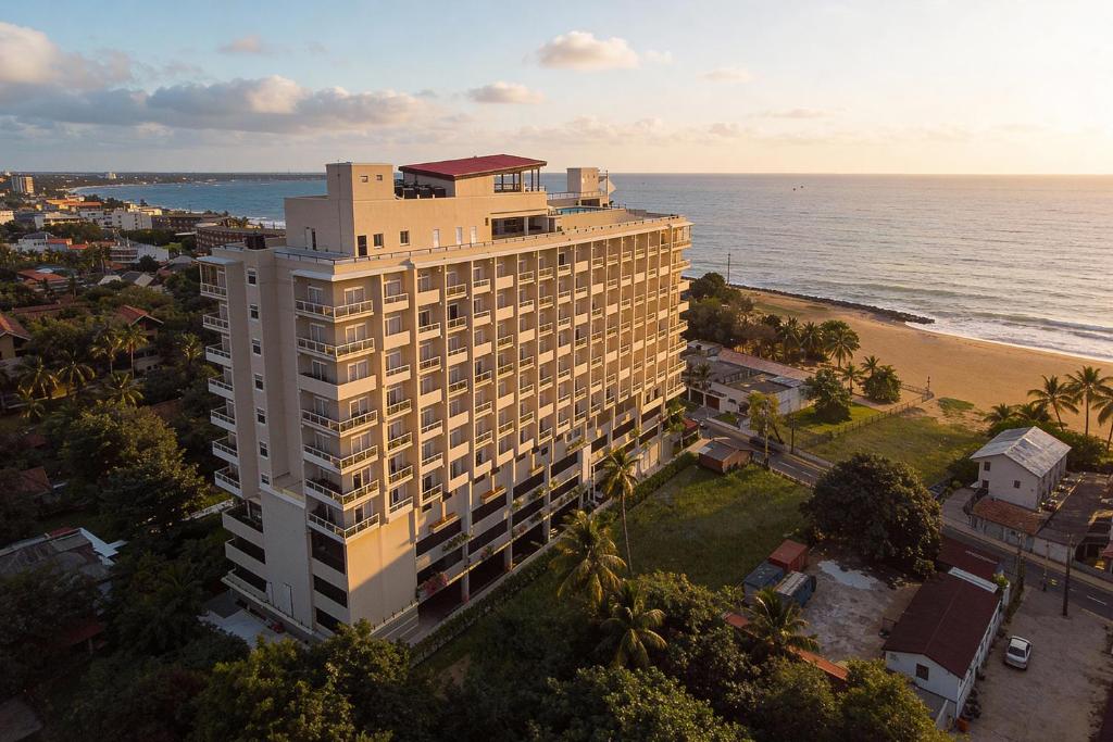 an aerial view of a building next to the beach at Corundum Breeze Negombo in Negombo