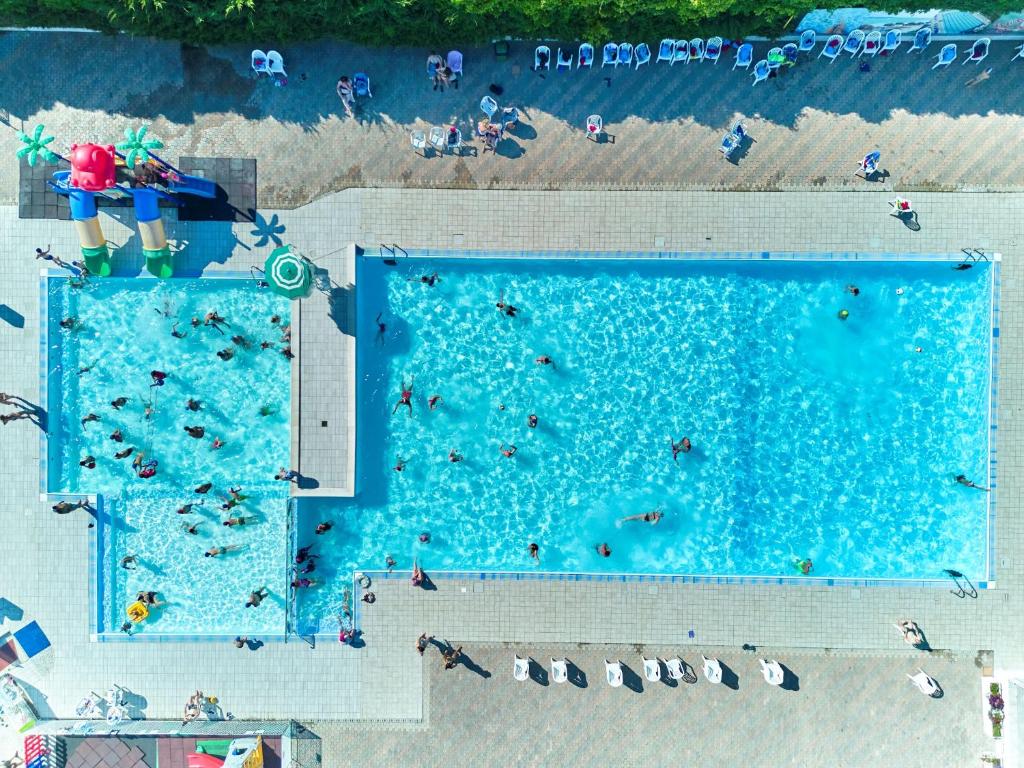 an overhead view of a swimming pool with people in it at Villaggio Camping delle Rose - Gatteo a Mare in Gatteo a Mare