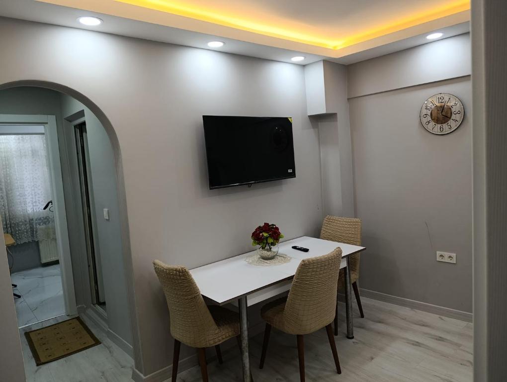 a dining room with a table and a tv on the wall at BlueRoyal Home Sultanahmet in Istanbul