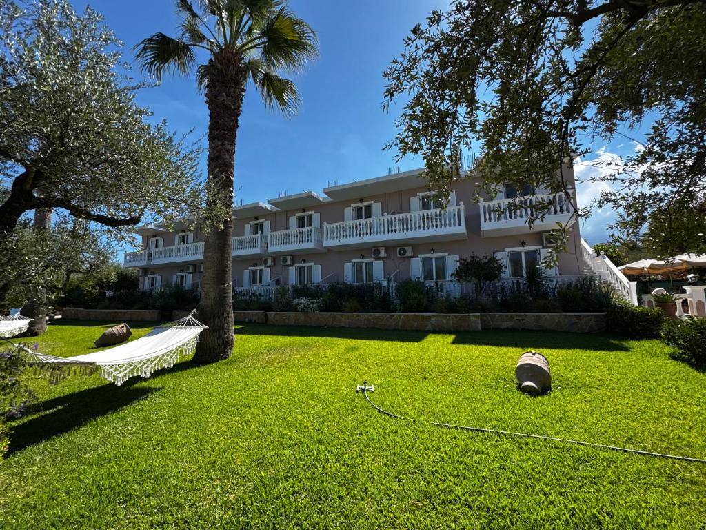 a large building with a hammock in a yard at Pelagos Studios in Amoudi