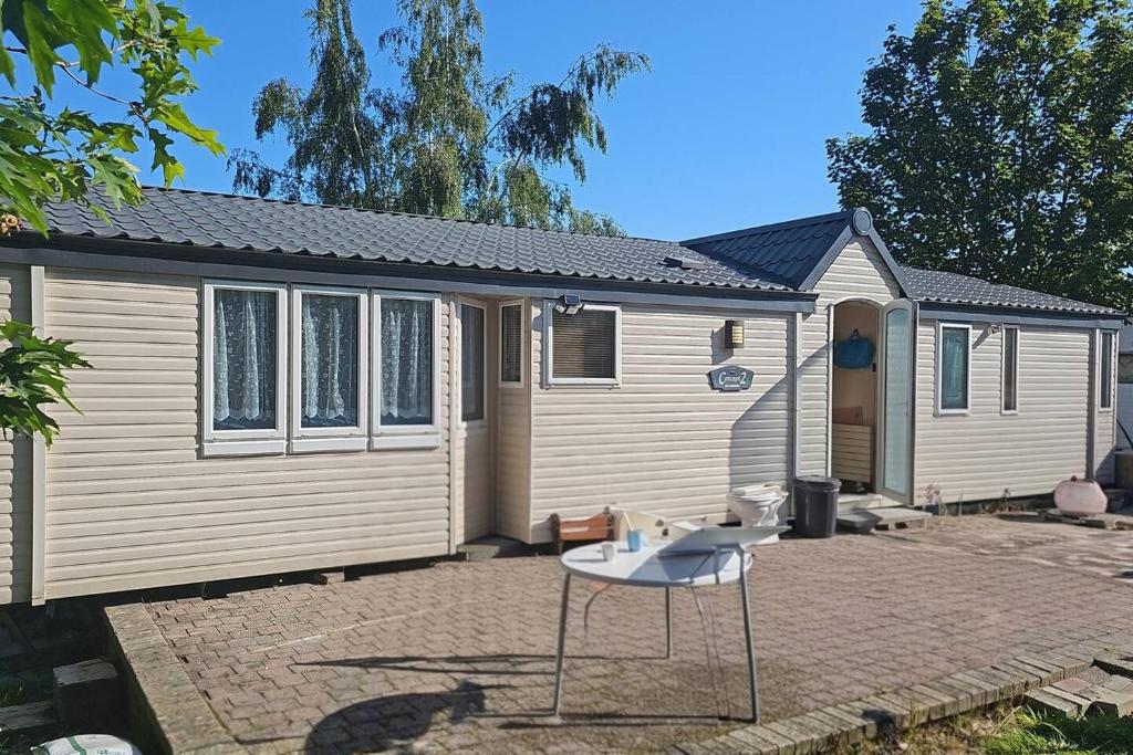 a tiny house with a table in front of it at La cabane des fées in Yvoir