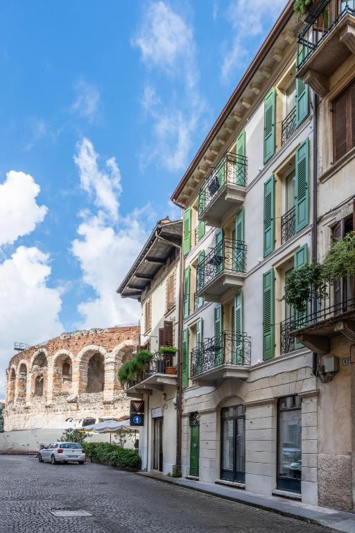 a building with balconies on a street in front of aiseum at Residenza Wega - Luxury Apartments Verona in Verona