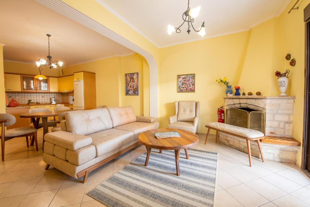 a living room with a couch and a fireplace at Aurora Apartment in Afitos