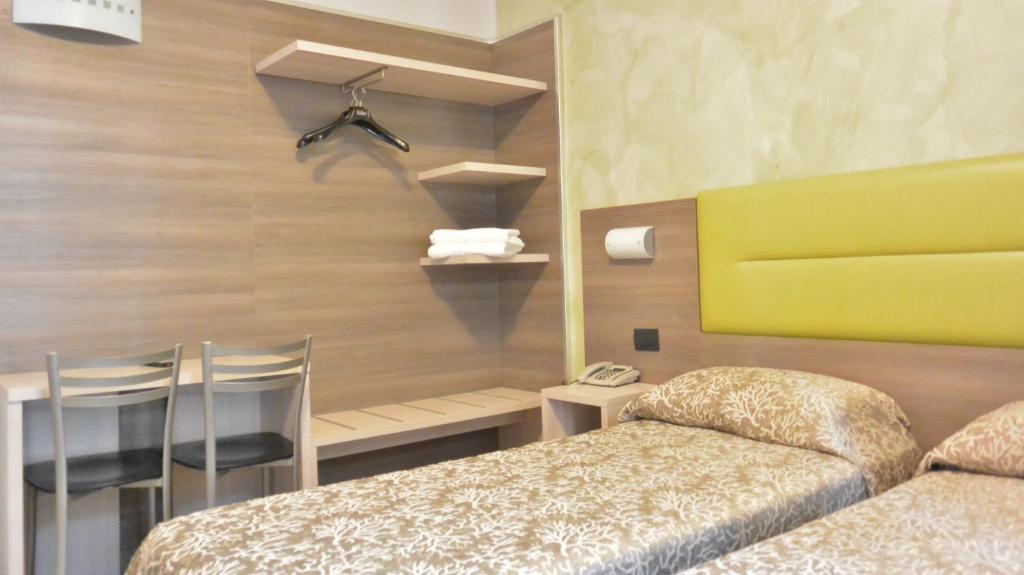 Postel nebo postele na pokoji v ubytování Hotel Siena