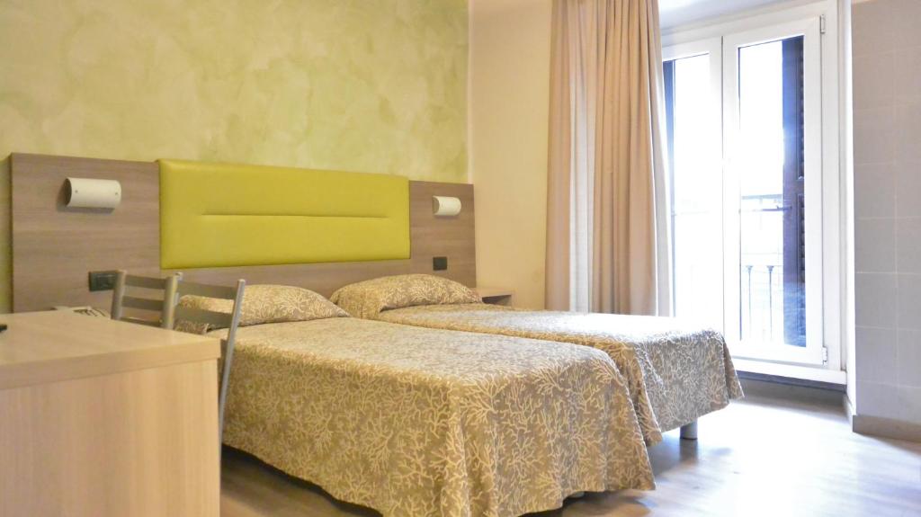 Postel nebo postele na pokoji v ubytování Hotel Siena