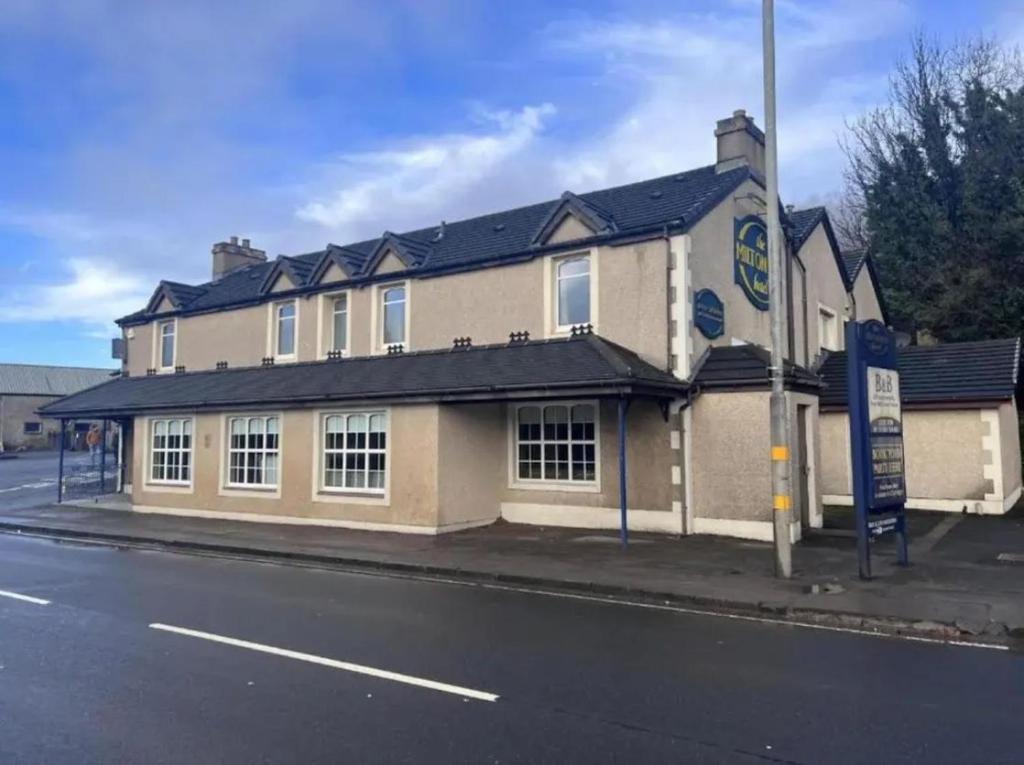 a building on the corner of a street at Lochway Hotel in Dumbarton