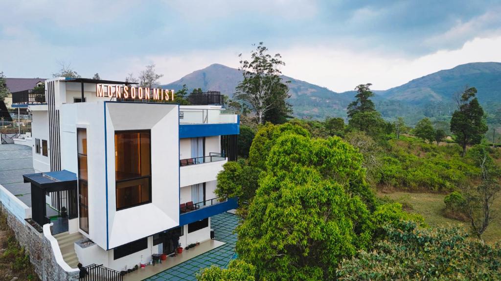 a view of a hotel with mountains in the background at Monsoon Mist Kerala in Pīrmed