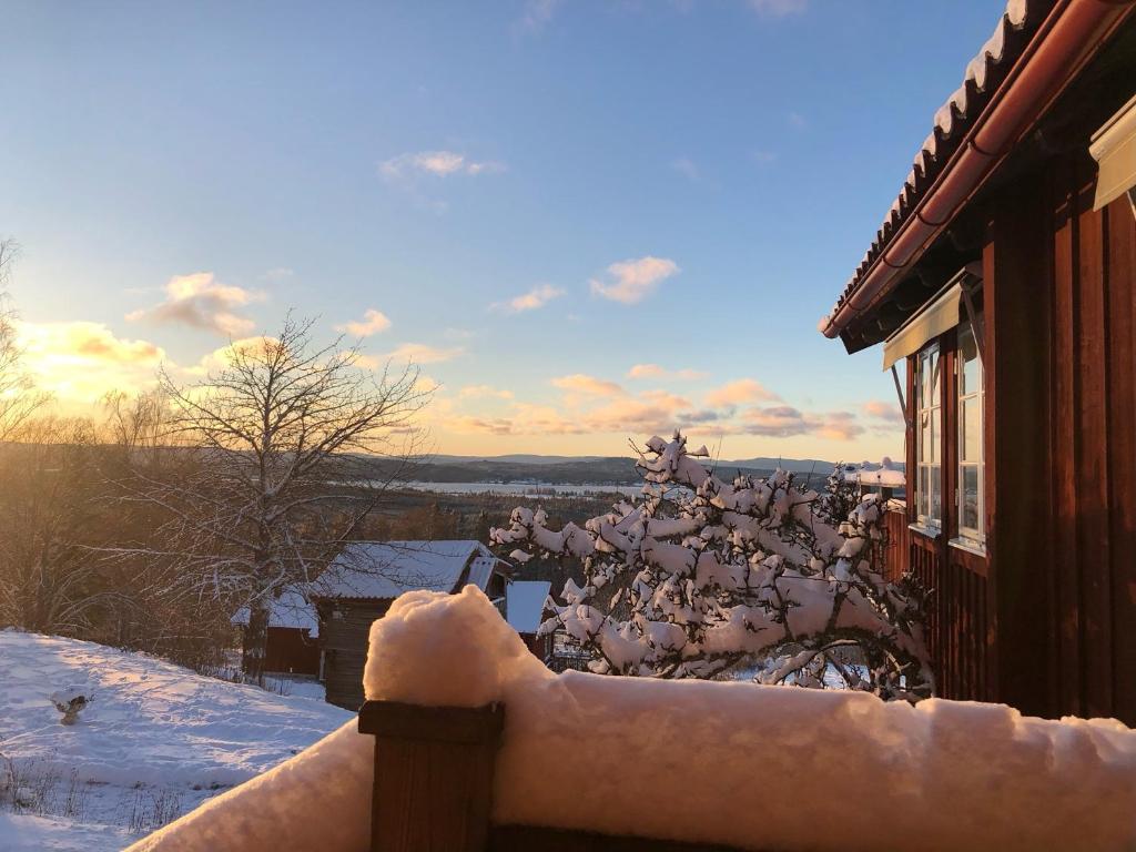 a fence covered in snow next to a building at Soltägtgården in Tällberg