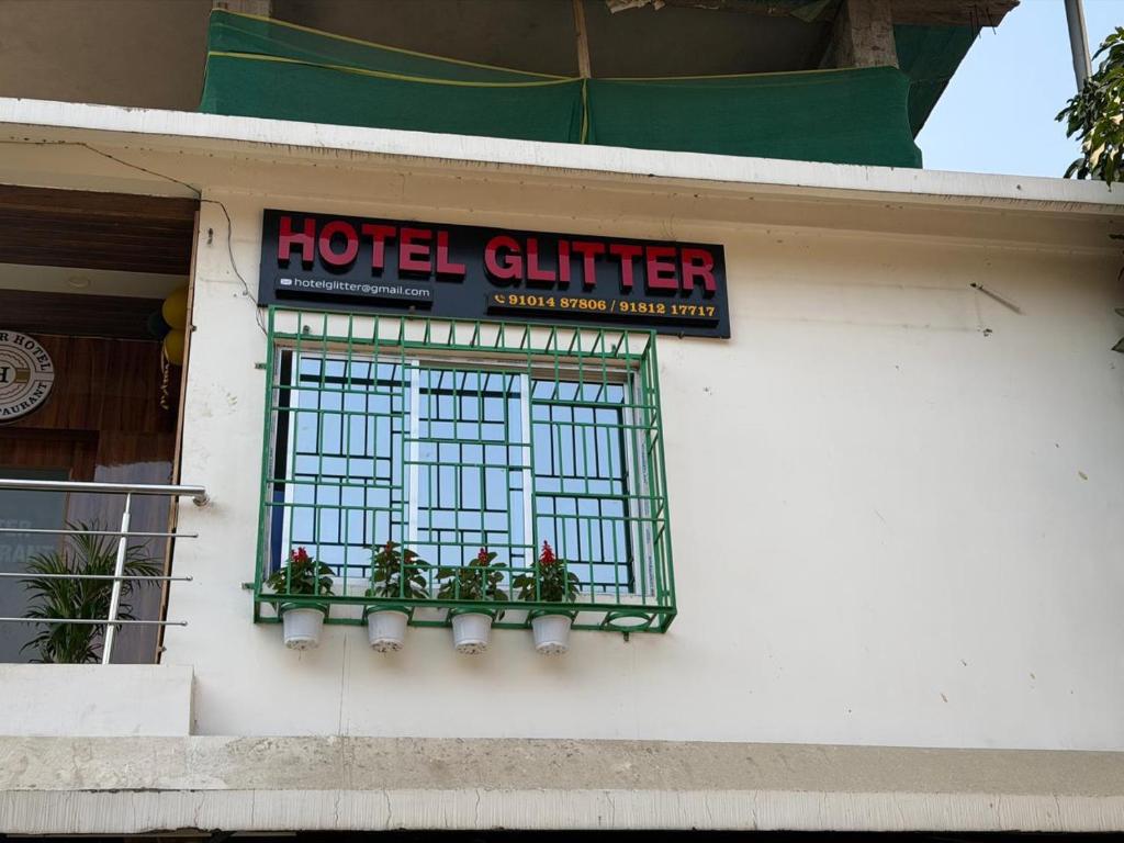 a hotel clier sign on the side of a building at Hotel Glitter in Guwahati