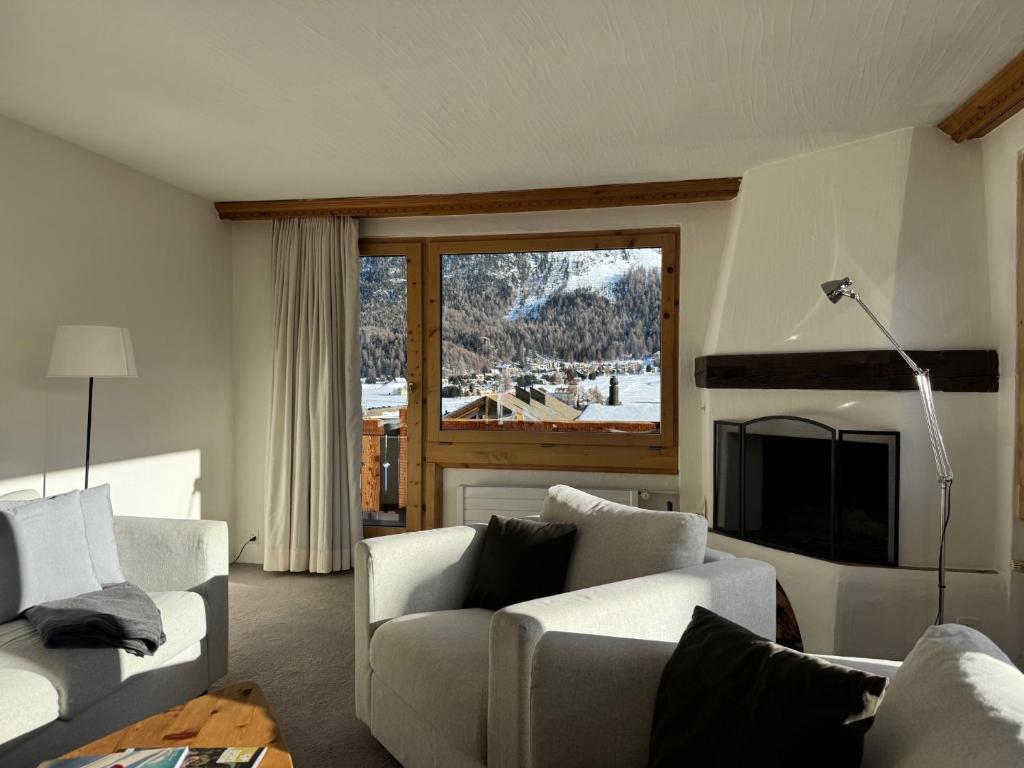a living room with two couches and a fireplace at Ferienwohnungen Albana in Silvaplana