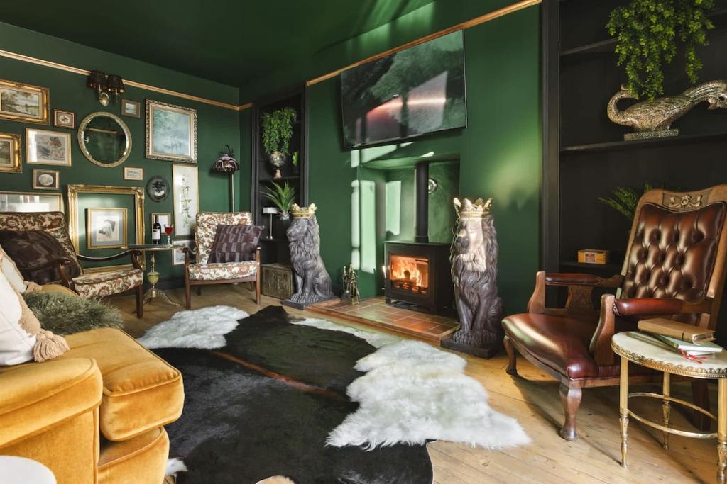 a living room with a couch and a fireplace at Old Earth - Ridgestone in Kendal