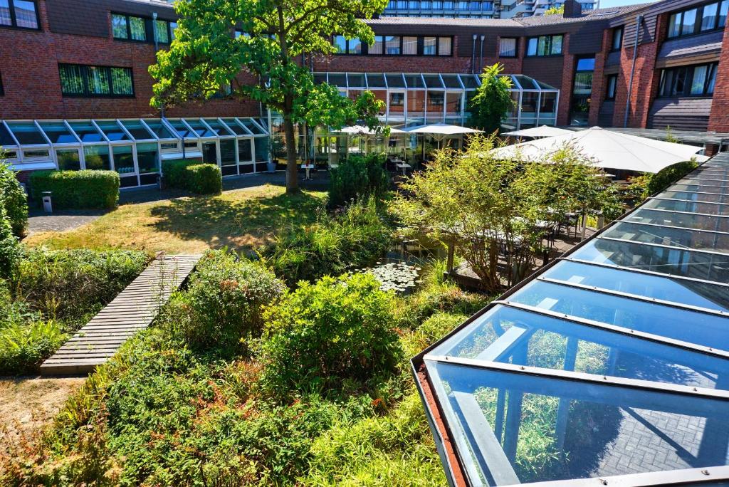 a view of a garden with a building at Hotel Gustav-Stresemann-Institut in Bonn