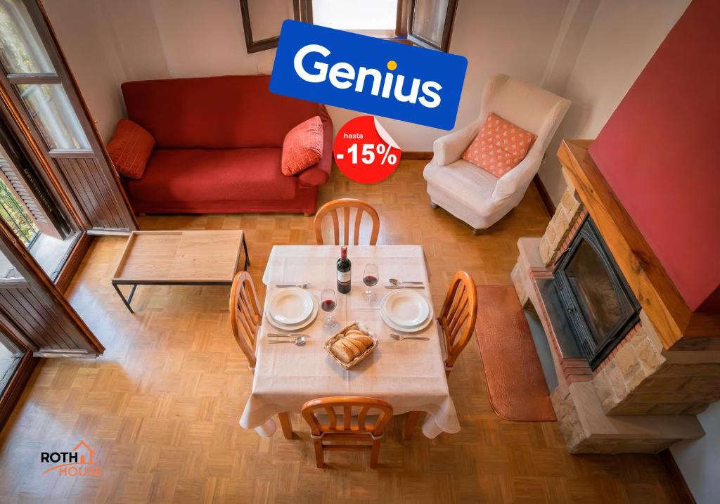 a table and chairs in a living room with a sign at Roth House in Ezcaray