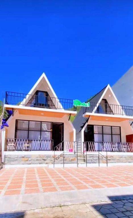 a house with a fence in front of it at Villa Syahdu1 Tawangmangu in Tawangmangu