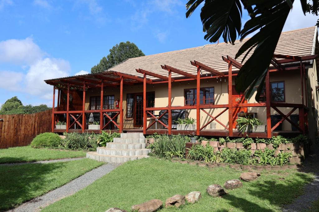 a home with a red and white building at FIG TREE HOUSE Entire holiday home, self catering, 4 bedroom, 2 bathroom, deck and garden in Durban