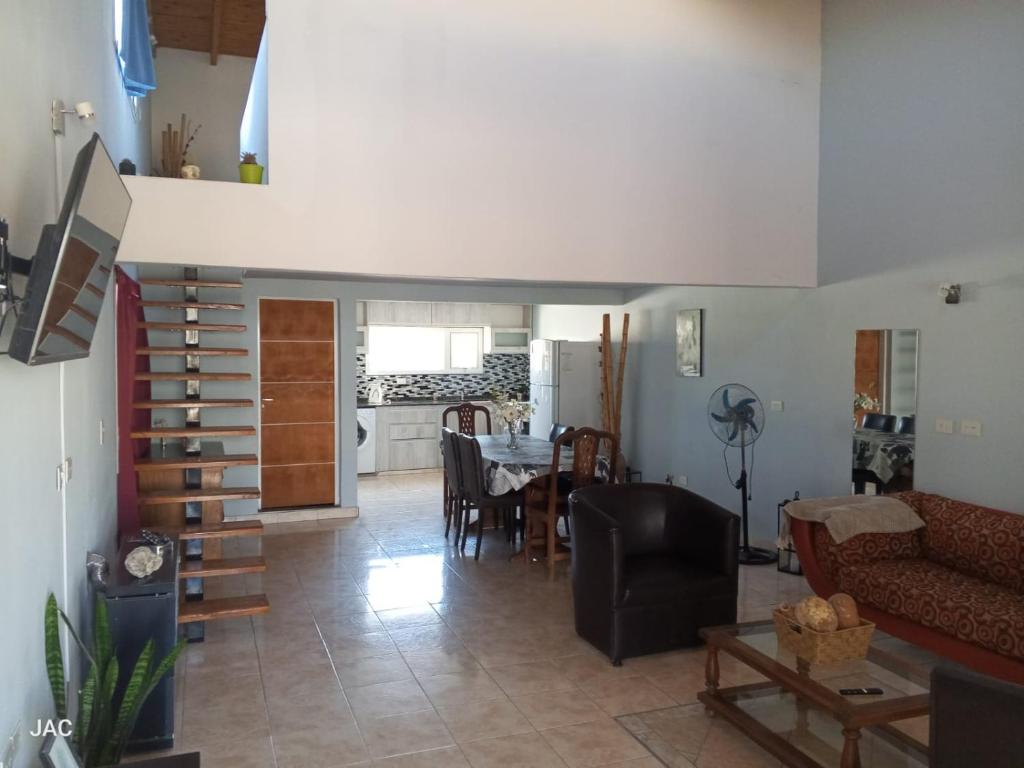 a living room with a couch and a table at Los del Sur cabañas in Comodoro Rivadavia