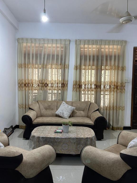 a living room with a couch and a coffee table at LOTUS HOLIDAY REST in Anuradhapura