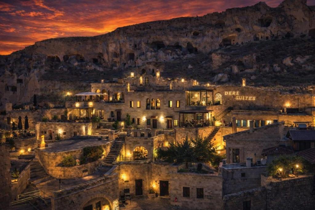 a city at night with a mountain in the background at Dere Suites Cappadocia in Ürgüp