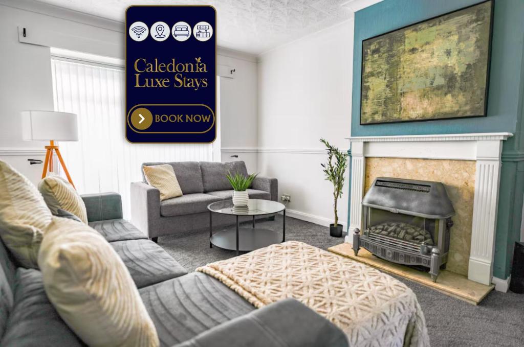 a living room with a couch and a fireplace at Elm House in Bathgate