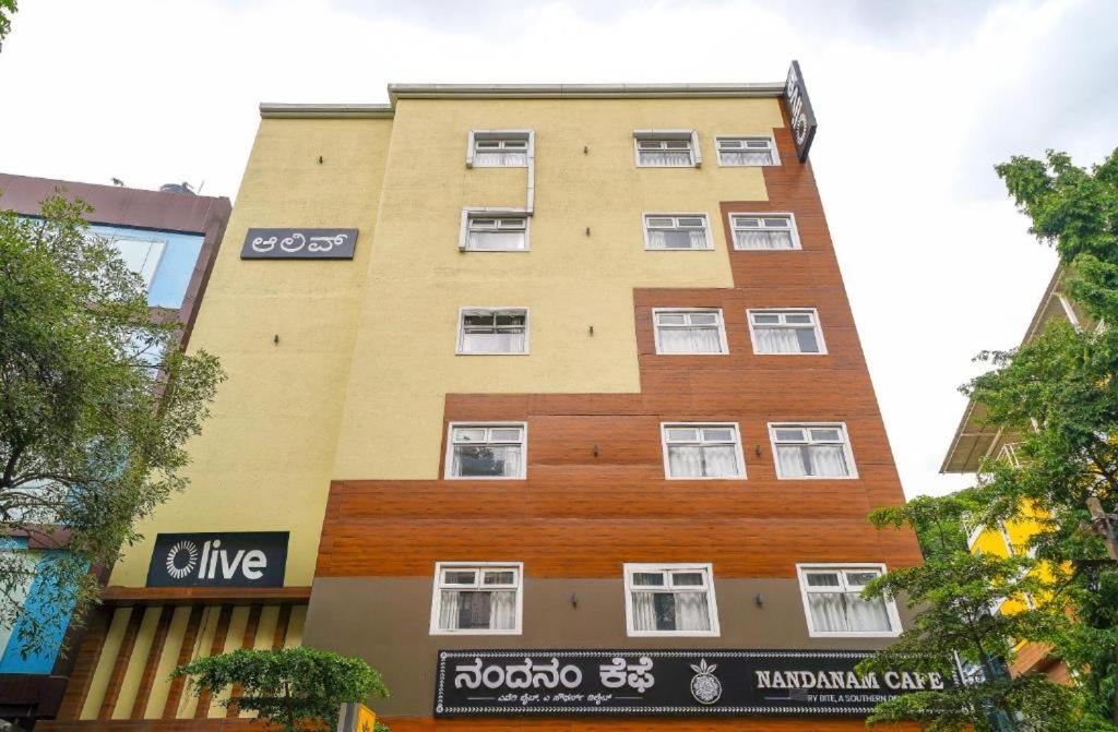 a tall building with a sign on it at SRS Vivanta in Bangalore