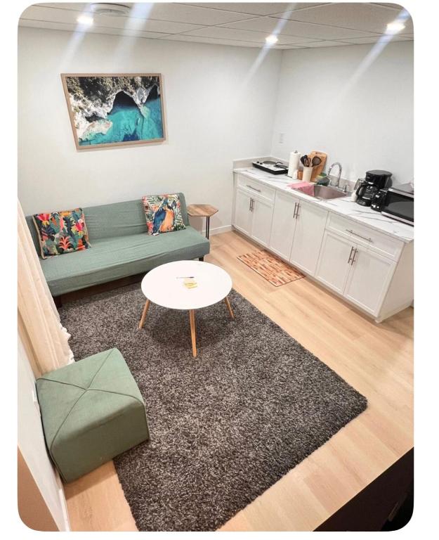 a living room with a couch and a table at Ubbies place in Regina