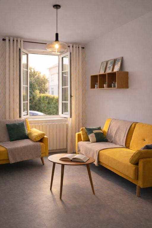 a living room with a yellow couch and a table at Appartements à Oloron in Oloron-Sainte-Marie