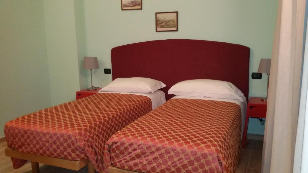 Postel nebo postele na pokoji v ubytování CerrutiHotel