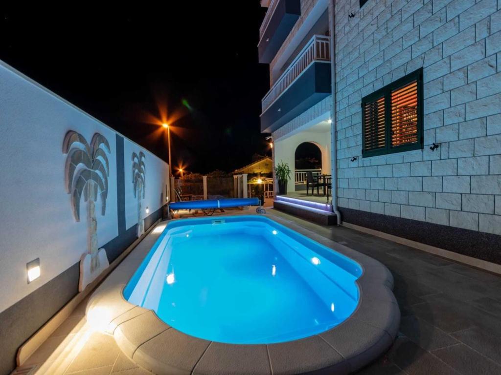 a swimming pool in the middle of a building at night at Villa Supe in Supetar
