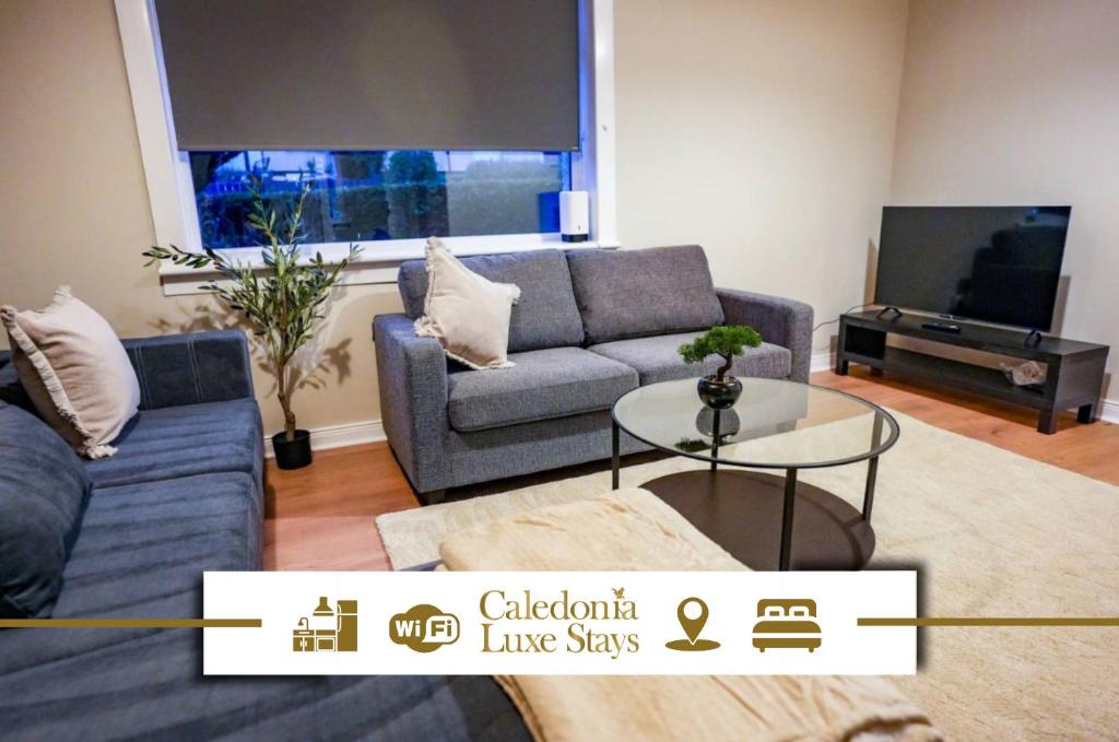 a living room with a couch and a table at Mayfield House in Dalkeith
