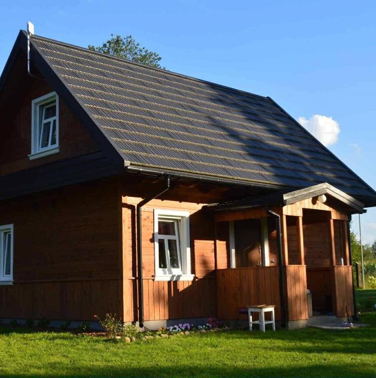 a house with a gambrel roof at Brzozowy Zakątek in Waśki