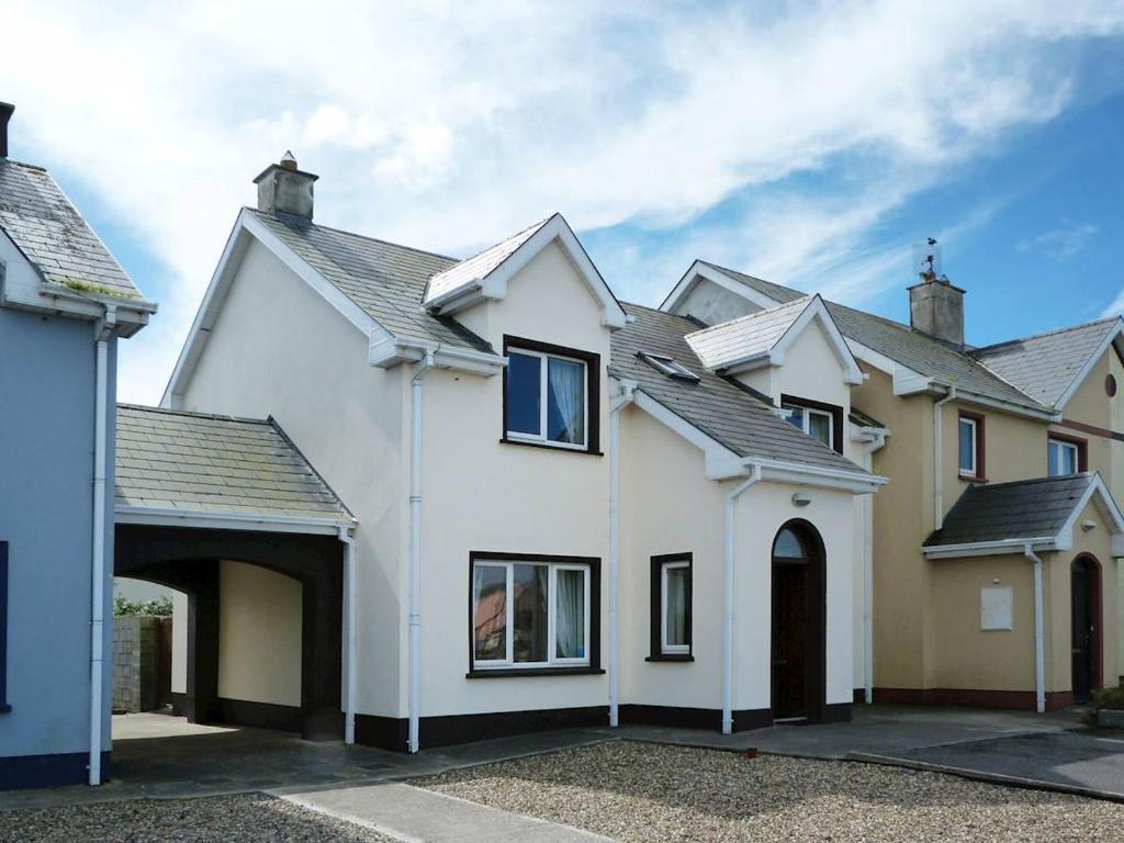 a large white house with a garage at 3 Bed in Doonbeg oc-ii15918 in Kilrush
