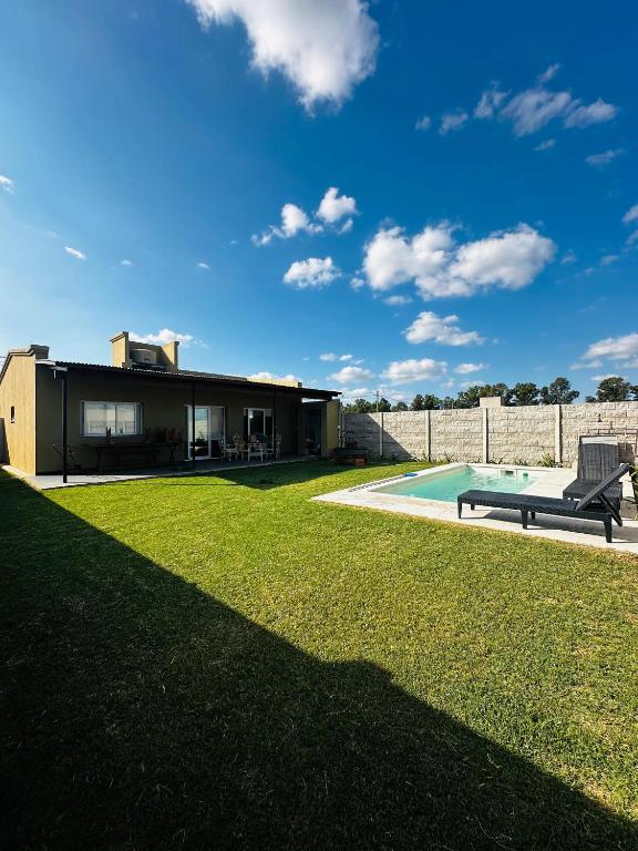 a house with a yard with a swimming pool at Los Agapanthus in General Belgrano