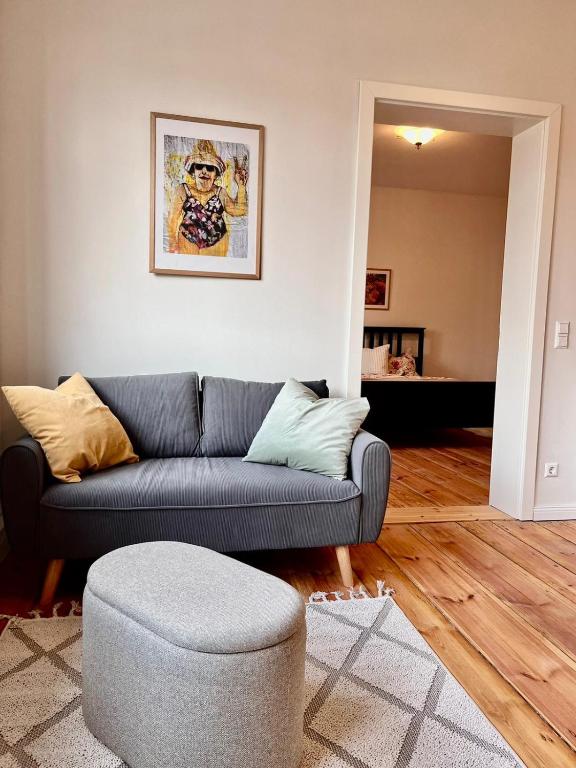 a living room with a blue couch and a chair at Ferienwohnung in Cammer