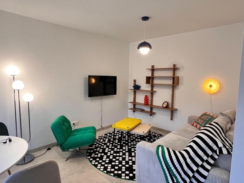 a living room with a couch and a table at Pop Mood Studio in Heillecourt