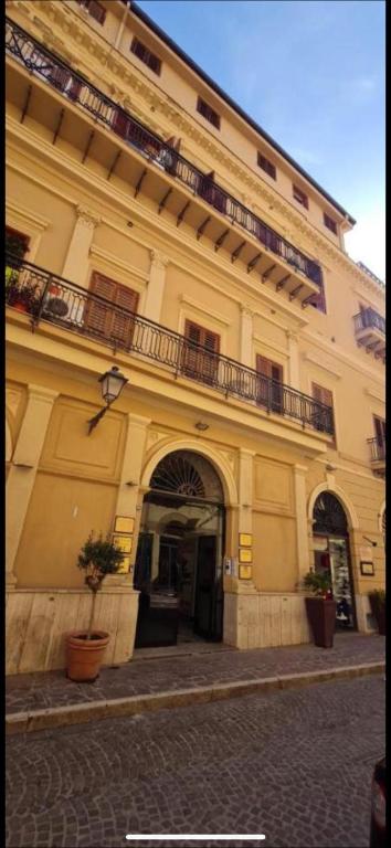 a large building with a balcony on top of it at M&S Home in Agrigento