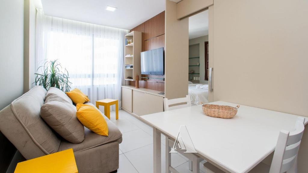 a living room with a couch and a table at Flat in Boa Viagem leisure great location PM805 in Recife