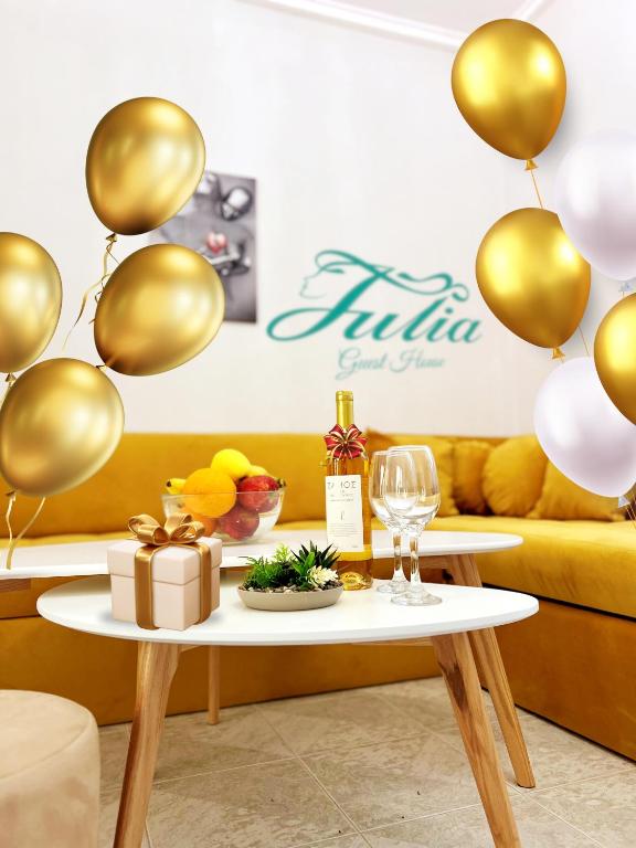 a table with a gift and balloons in a room at Guest House Julia in Stavros