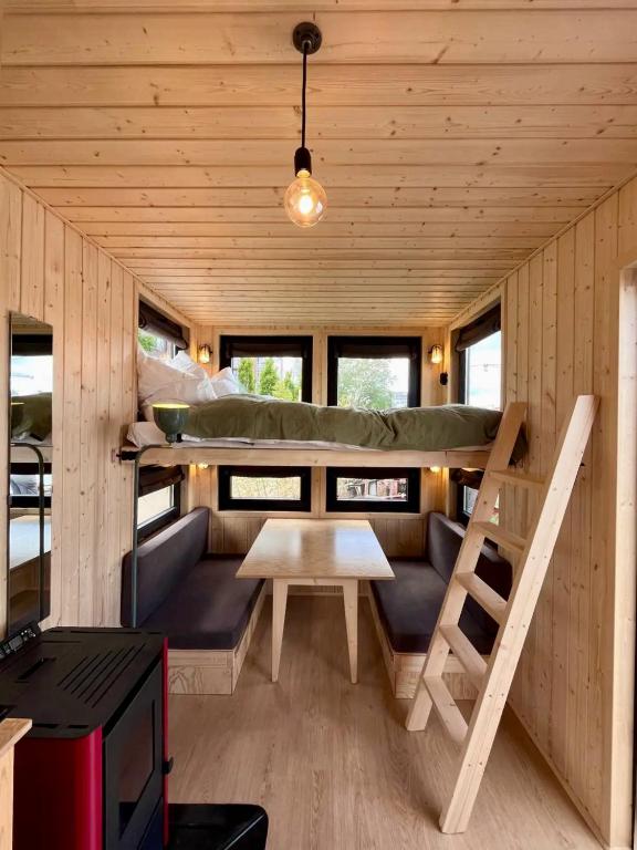 a living room of a tiny house with a couch and a table at Berlin River Retreat in Berlin