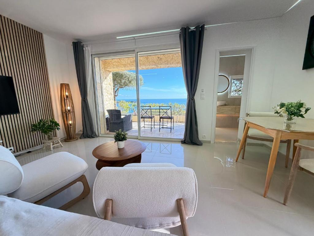 a living room with a view of the ocean at Villa Grand Baie in Agay - Saint Raphael