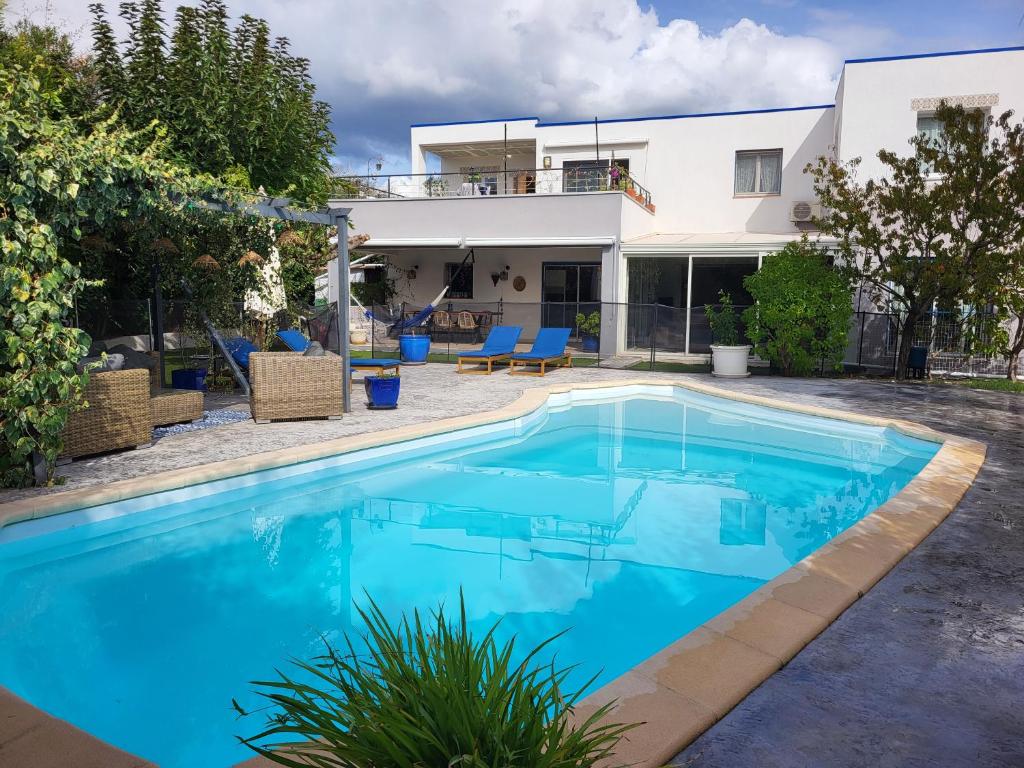 a swimming pool in front of a house at Bas de villa moderne avec piscine in Fréjus