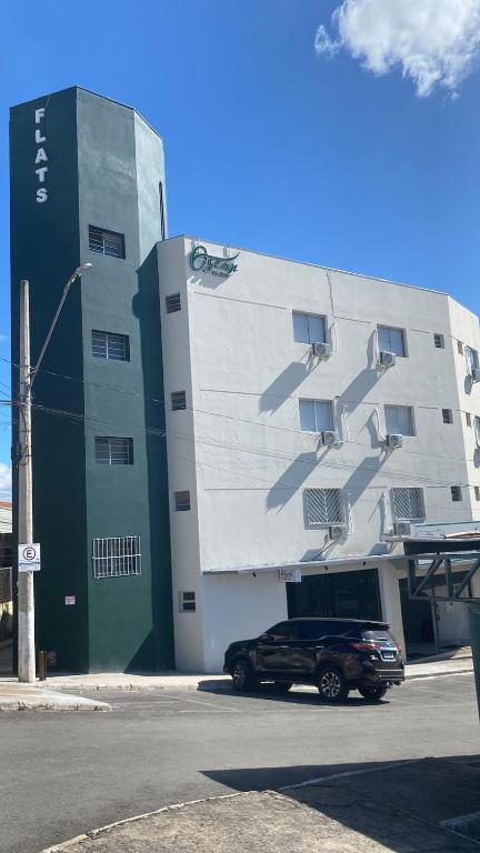 a black car parked in front of a building at Oscar flats in Montes Claros