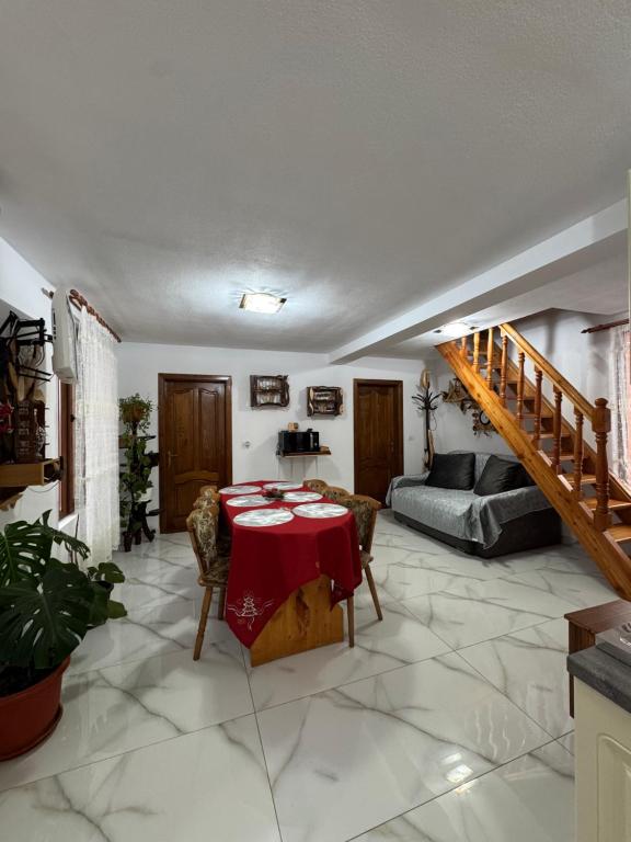 a living room with a table and a couch at Cabana Violeta Arieseni in Arieşeni