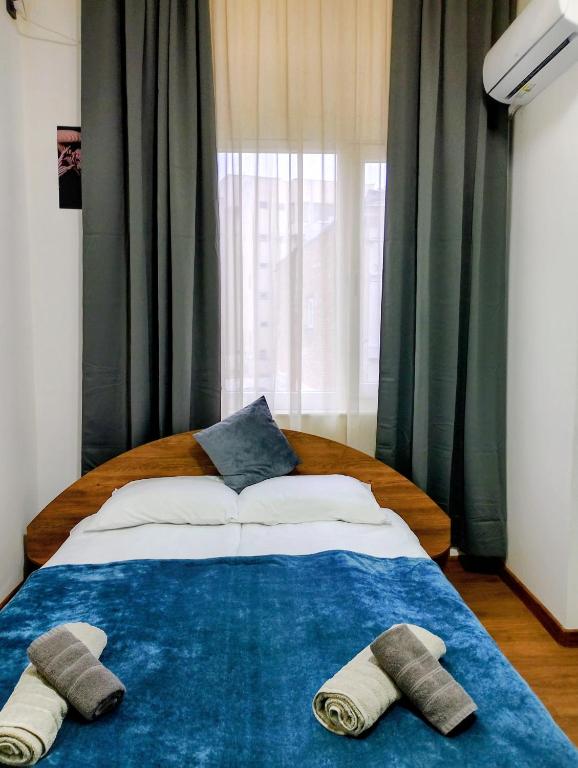 a bedroom with a bed with two slippers on it at GuestHouse5 KARMA369 in Plovdiv