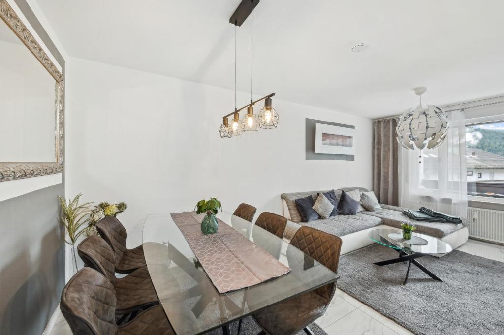 a living room with a table and a couch at Ramoni Apartments - Lichtblick in Enzklösterle