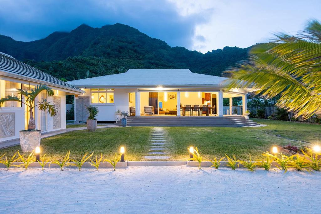 a house with lights on the lawn in front of it at Villa Kahia in Teavaro