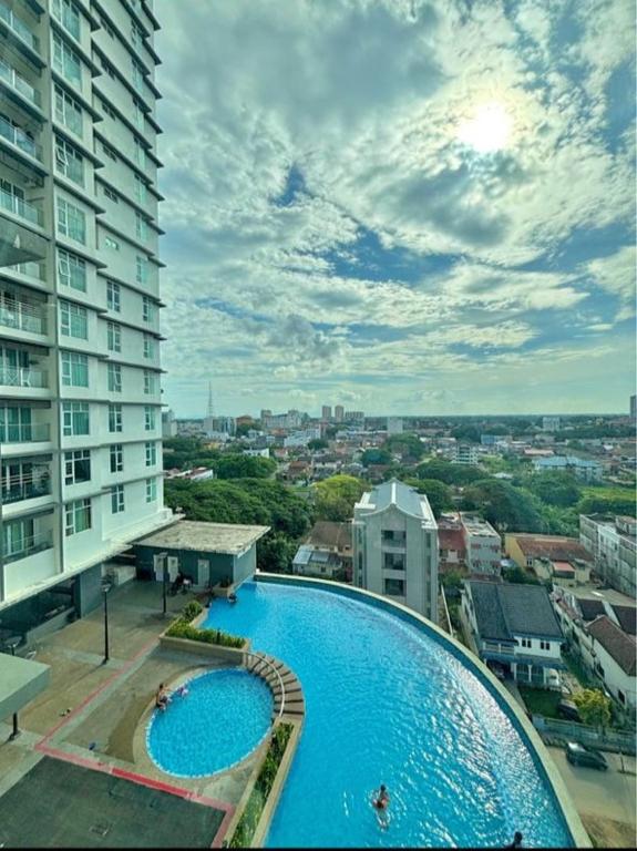 an overhead view of a large swimming pool in a city at Aisyah Studio D perdana in Kota Bharu