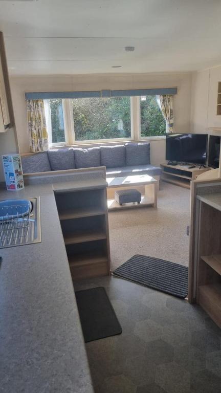 a living room with a couch and a table at 87 Mountain View, Hafan Y Mor in Afon Wen Junction