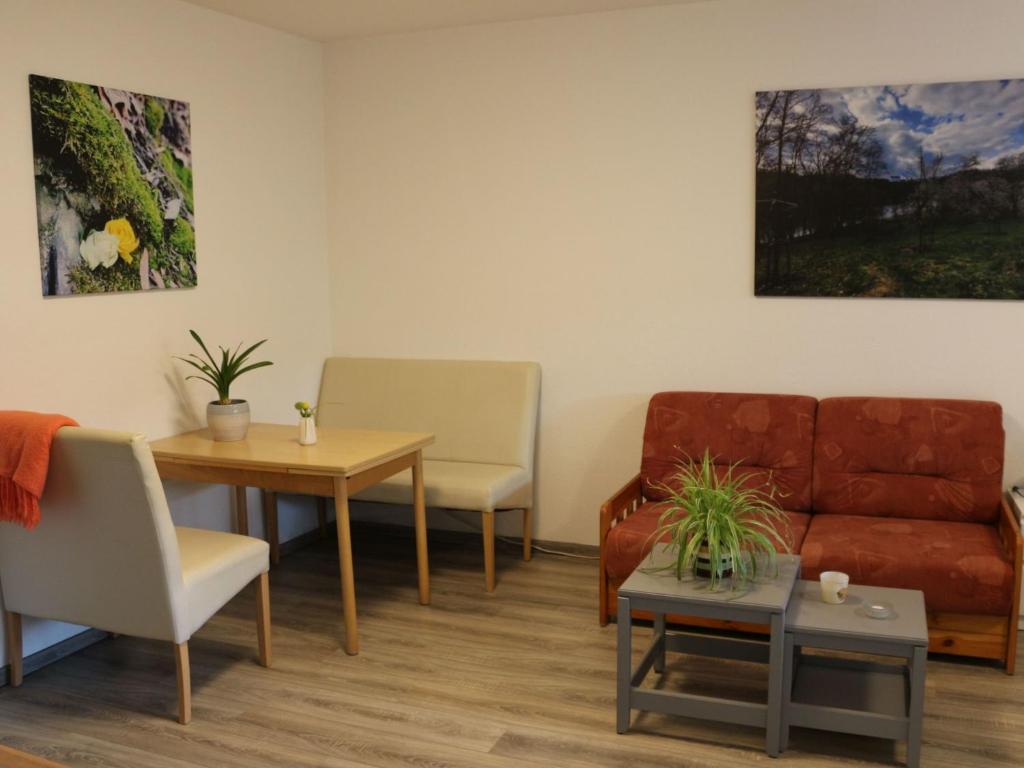 a waiting room with a couch and a table at Apartment Paula by Interhome in Neundorf